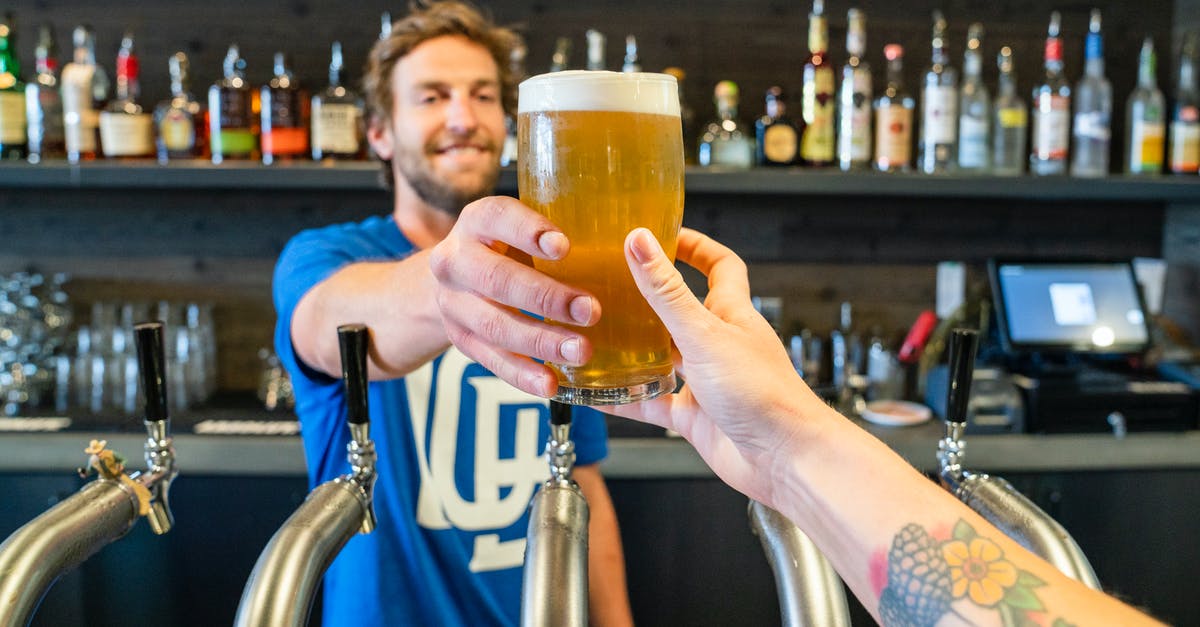 Received gestures in UK pubs: pint versus half-pint - Man Handing a Person a Glass of Beer