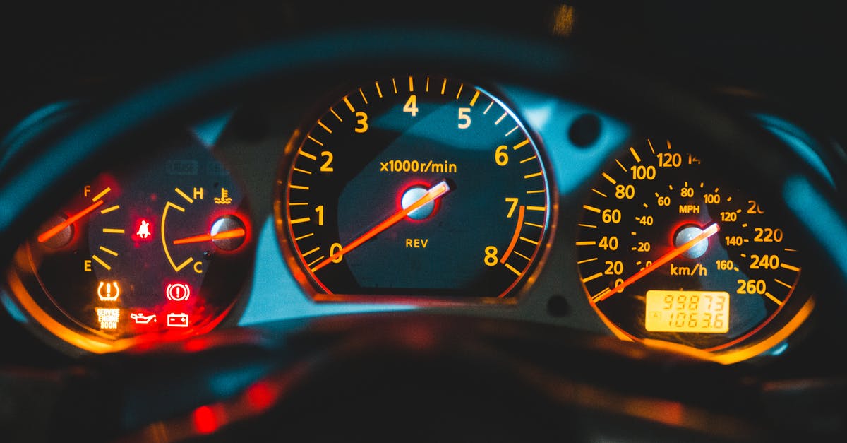 Red triangle, yellow jackets, etc. for rental cars in France - Closeup of tachometer near speedometer and oil pressure gauge on colorful dashboard in modern car