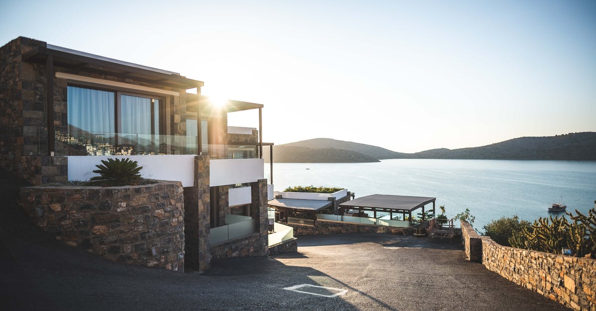 Re-enter Schengen with a residence card - Sun Piercing of Brown Concrete House Near Sea