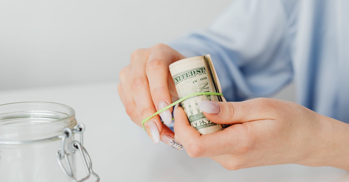 reenter US after using medicaid for childbirth [closed] - Close-Up Shot of a Person Using Rubber Band to Tie Up the Paper Money