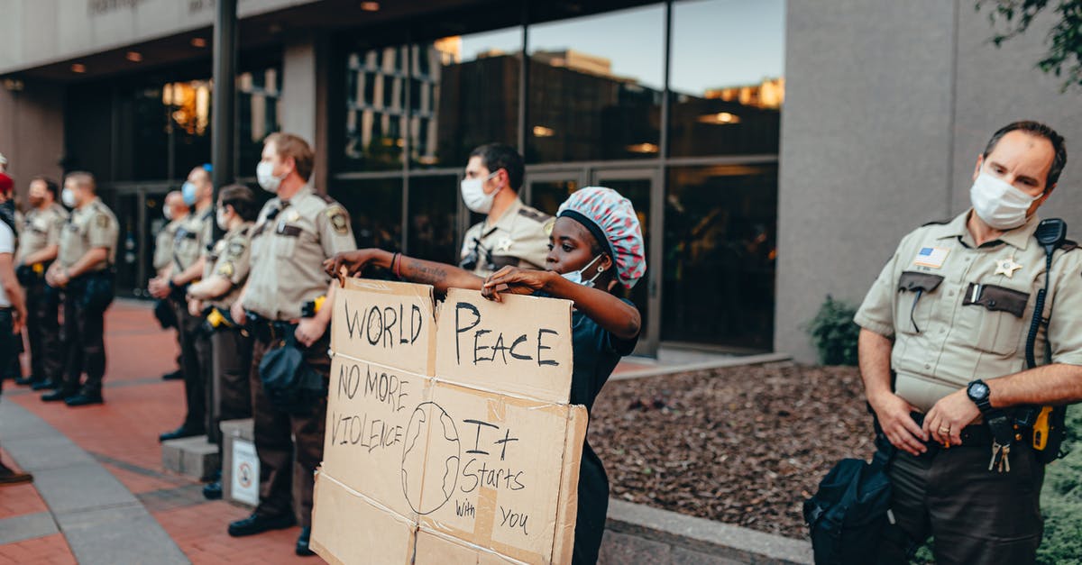 Re-entering Canada after minor contact with the police there - Person Protesting next to Cops