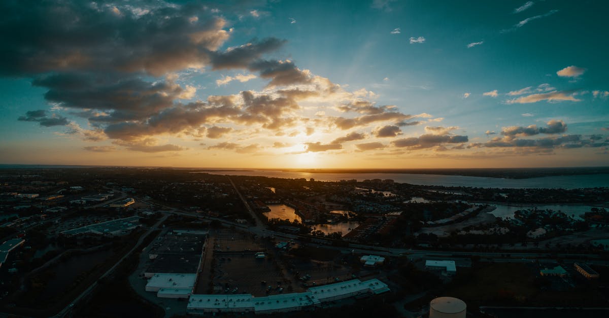 Reentering the Schengen area when visiting without visa [duplicate] - Aerial view of contemporary town district with low level buildings near peaceful river at sunset