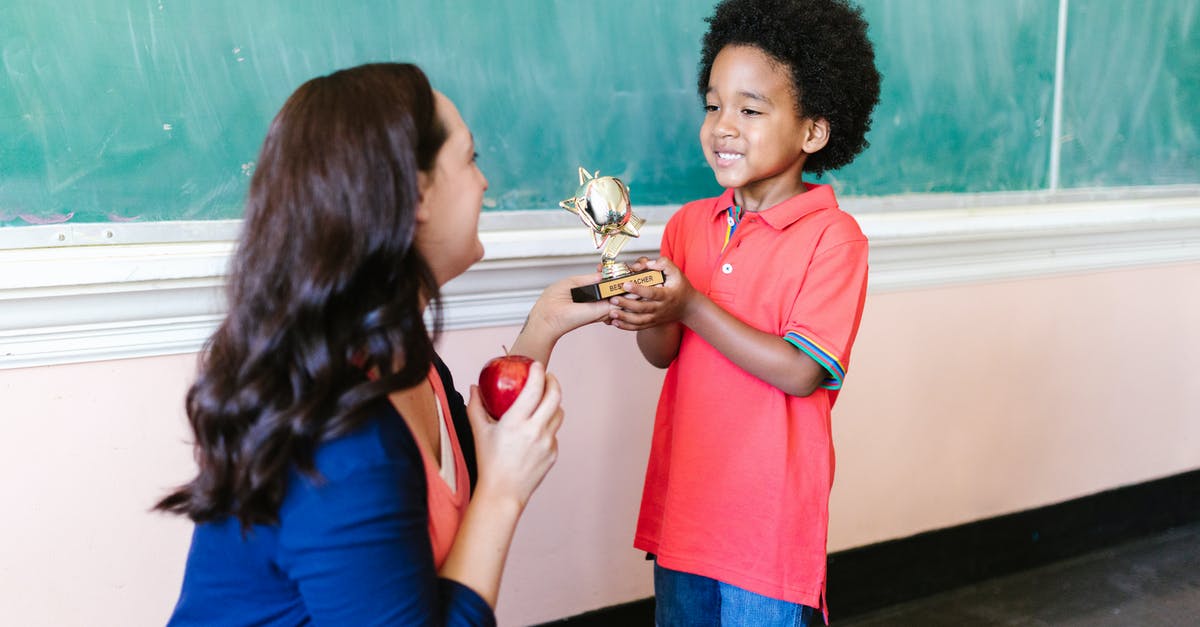 Re-entering the UK have short-term student child unaccompanied visa - Little Boy in Red Polo Shirt Holding Gold Trophy