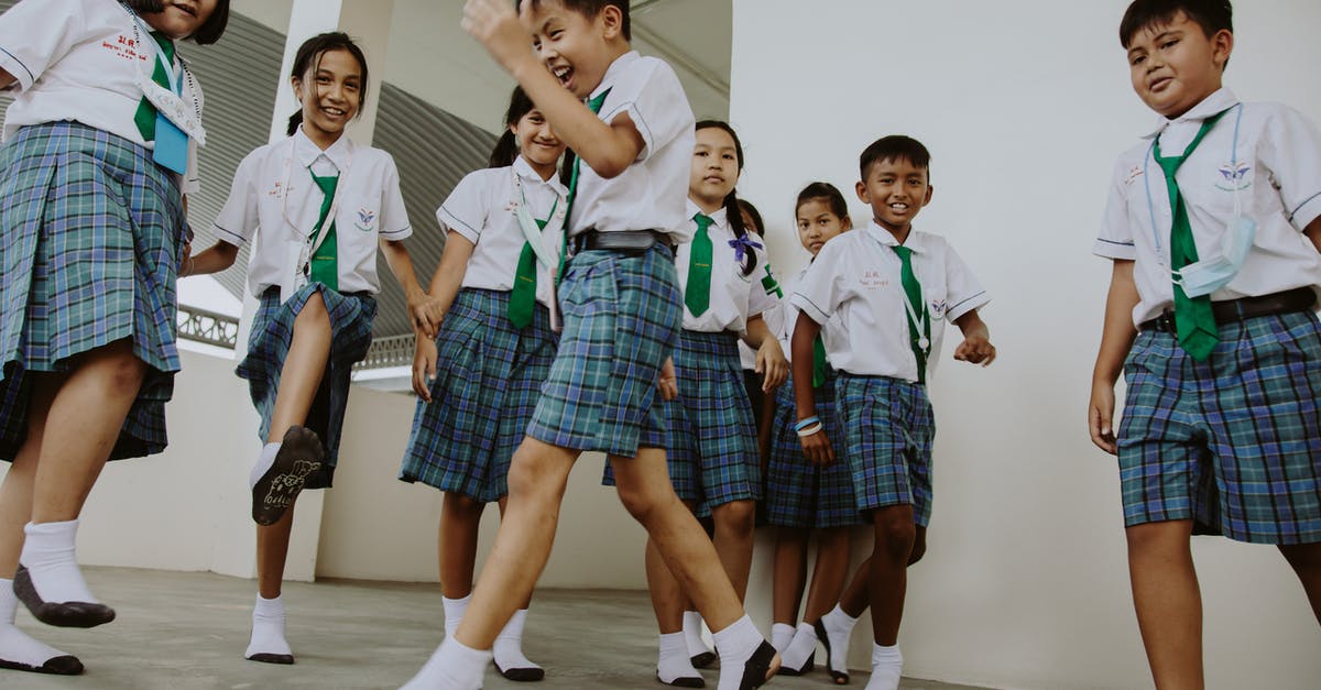 Re-entering the UK have short-term student child unaccompanied visa - Smiling Boys and Girls in School Uniforms Playing in School Gymnasium