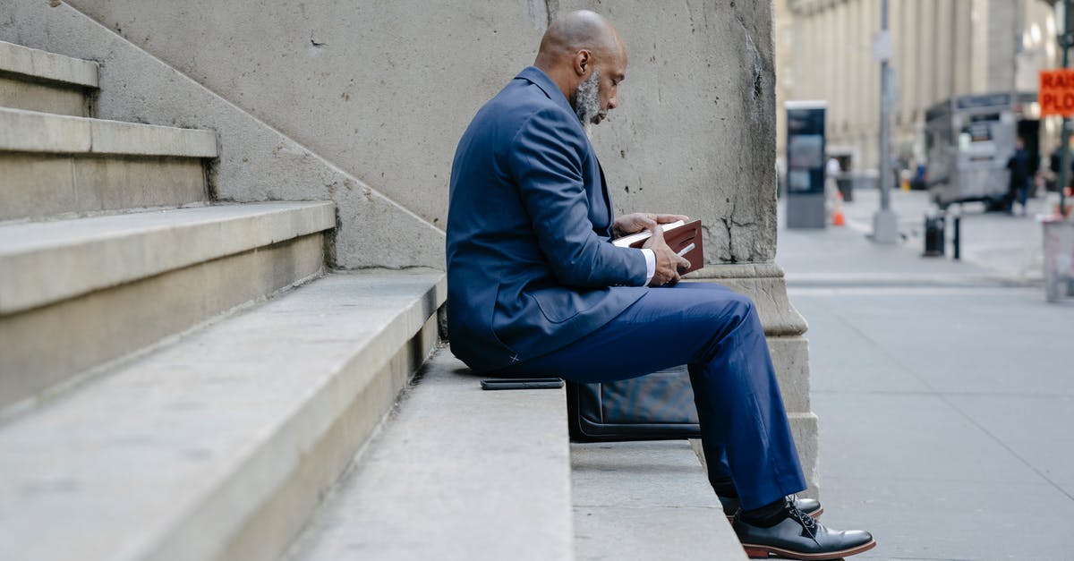 Refusal or Ban ? What steps next? - Man in Blue Suit Jacket and Blue Pants Sitting on Concrete Bench