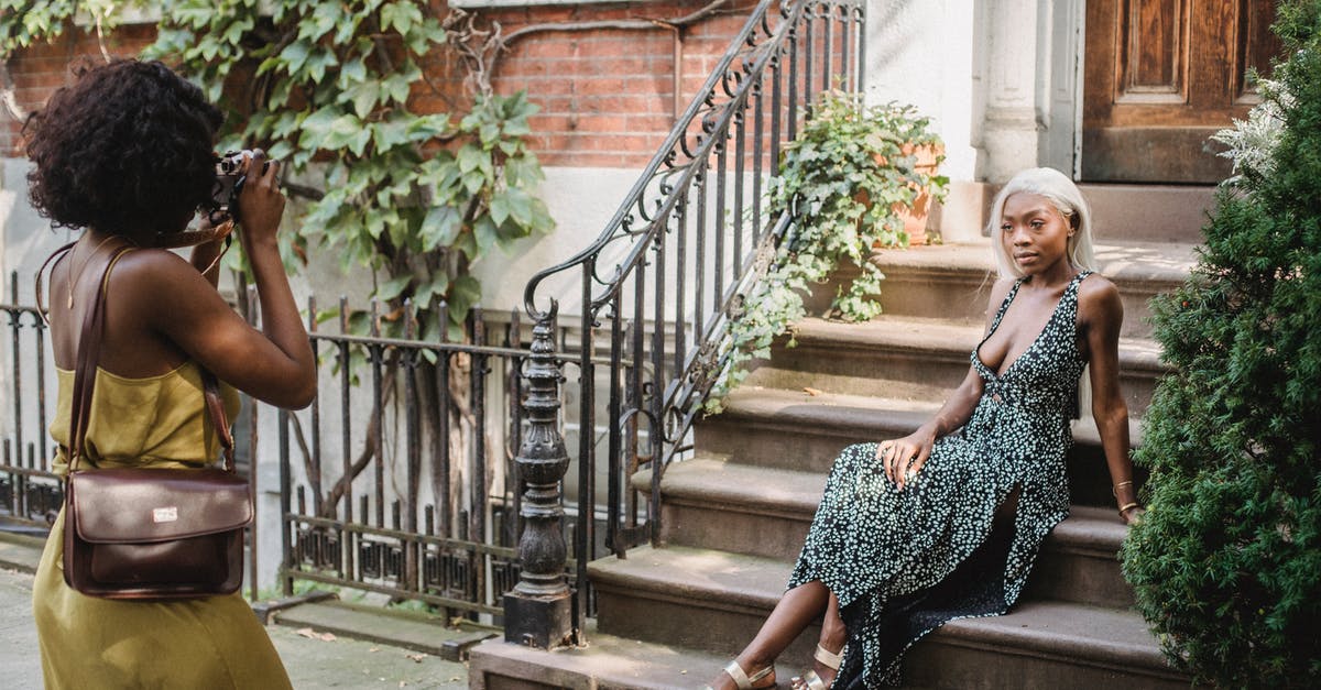 Refusal or Ban ? What steps next? - Woman in Black and White Dress Standing on Brown Wooden Staircase