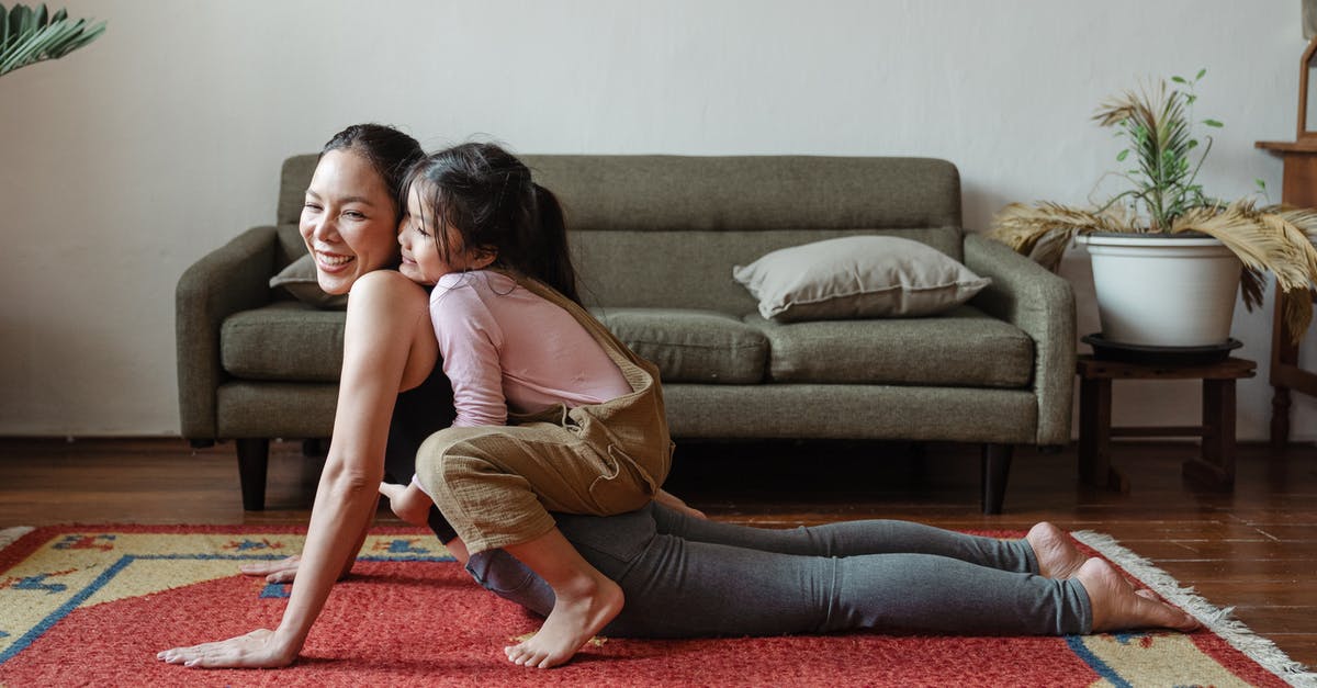 Refused family ticket due to not being a "family" - Photo of Girl Hugging Her Mom While Doing Yoga Pose