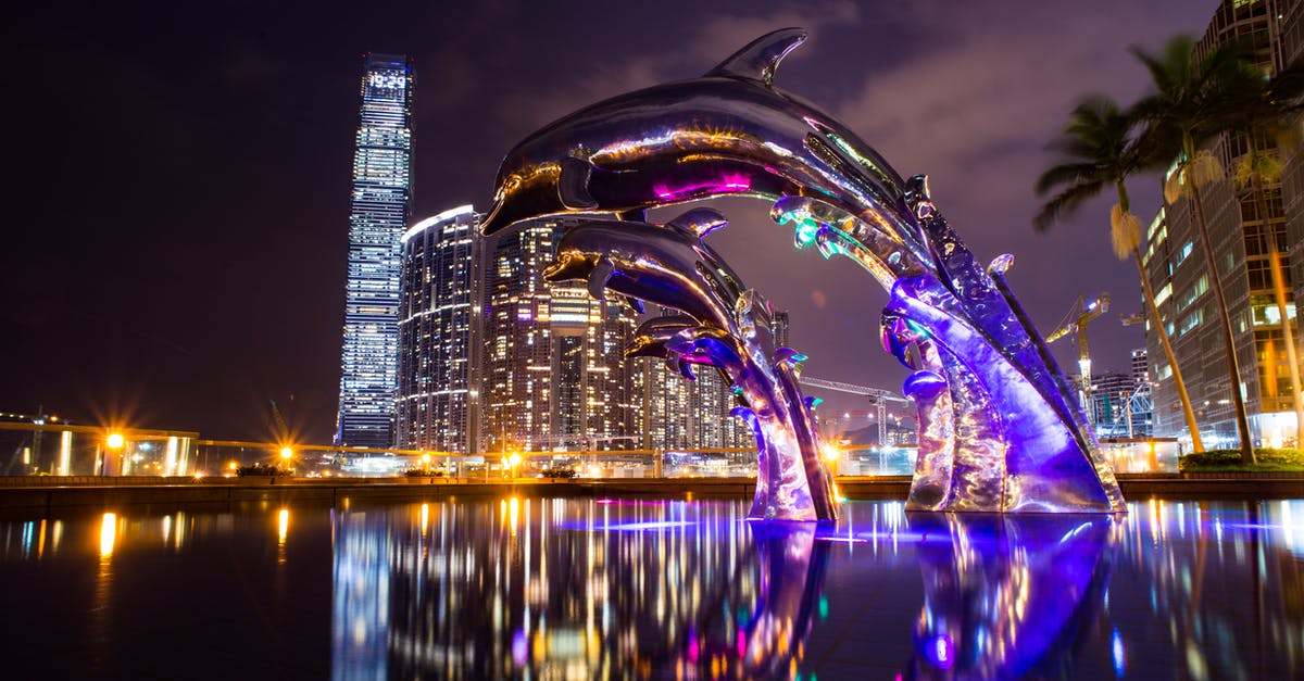 Regarding transit via HongKong - Low Angle Photography of Dolphin on Fountain