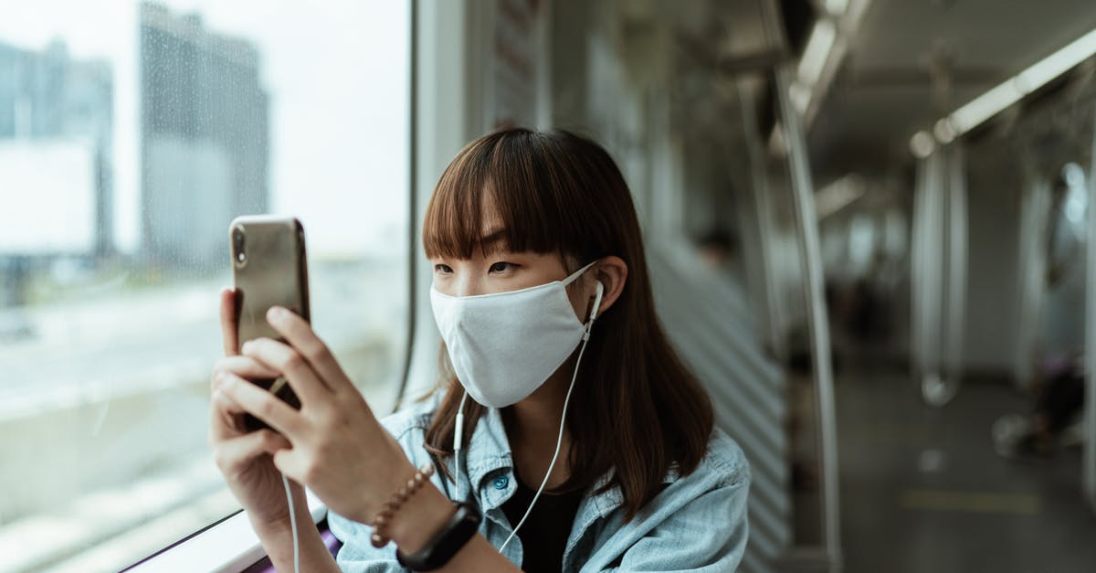 Reliable mobile provider on the train from Utrecht to Eindhoven? - Woman Wearing a Face Mask on the Subway