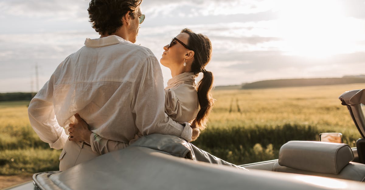 Relocation/Cheap Car Hire [closed] - Man and Woman Sitting on White Car