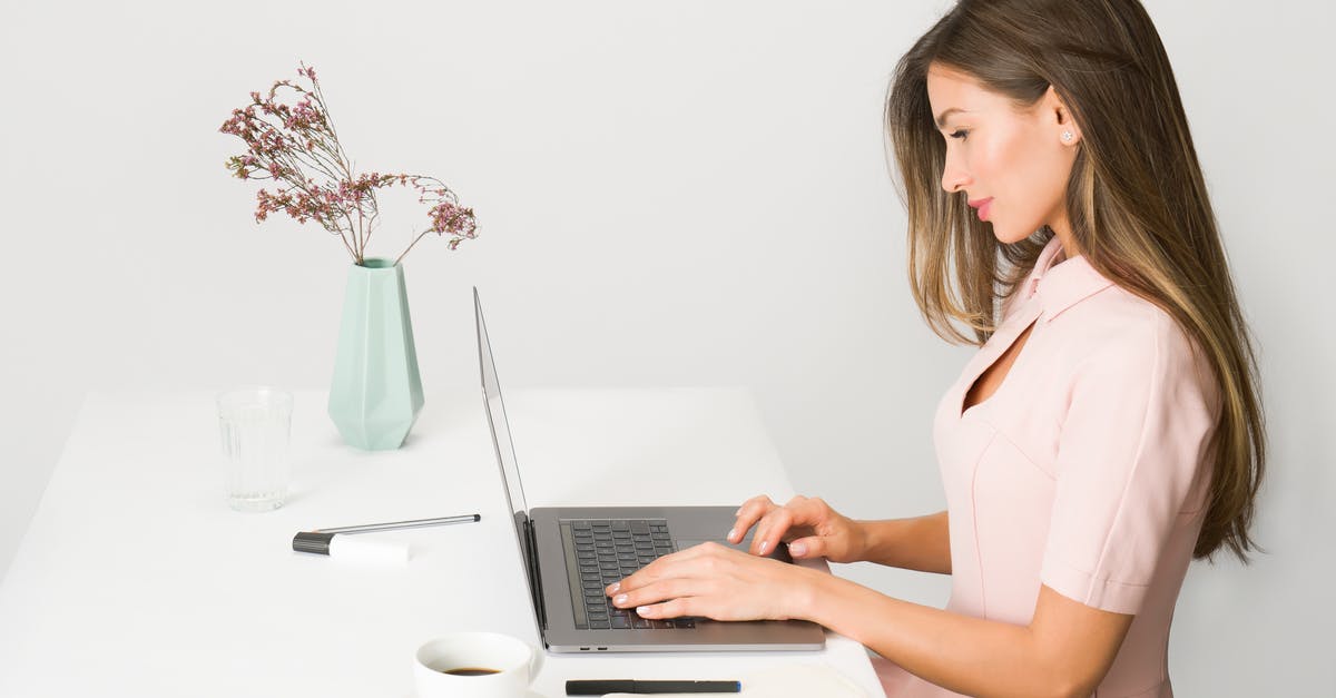 Remote Working While Travelling - Visa Requirements? - Woman in Pink Dress Using Laptop Computer