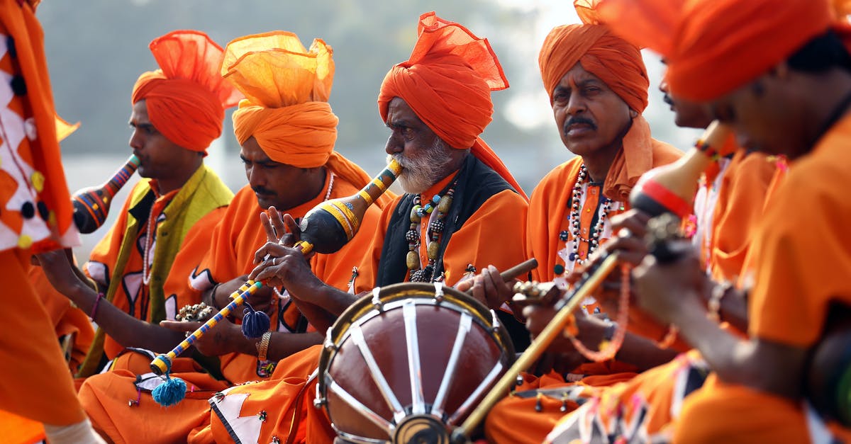 Renewing my Indian passport in India as an NRI - Men in Orange Costumes Playing Instruments