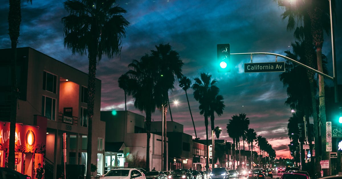 Rent a car at Palm Springs airport - Busy city street in tropical town at night