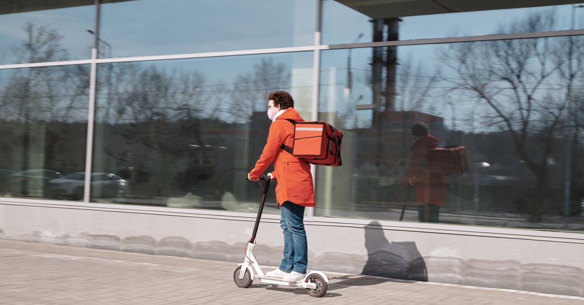 Rent a scooter for 2 weeks in Bali - Delivery Man Wearing a Face Mask and Riding a Scooter