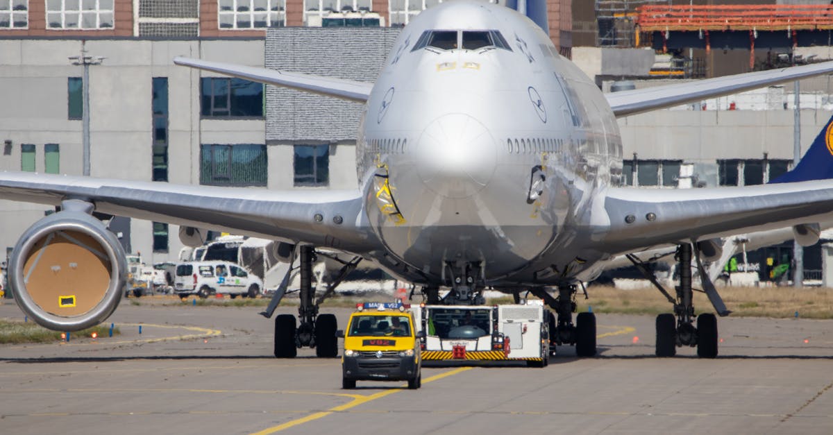 Renting a van out of Geneva airport - Photo of an Airplane Behind a Black and Yellow Van