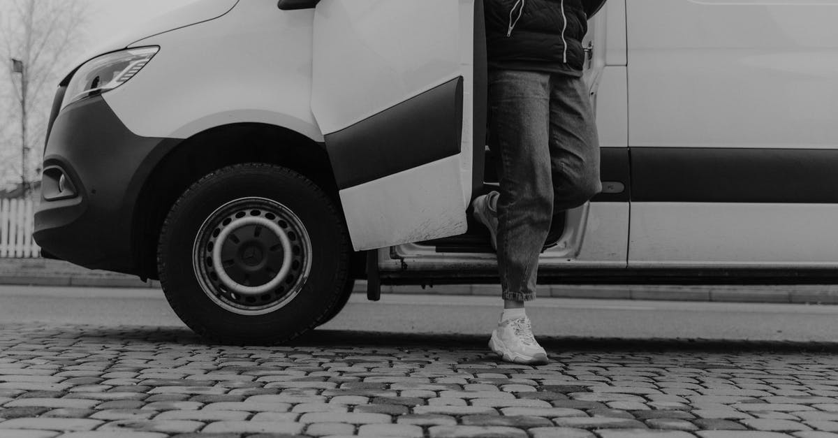 Renting a van out of Geneva airport - Grayscale Photo of a Man Getting Out of the Vehicle