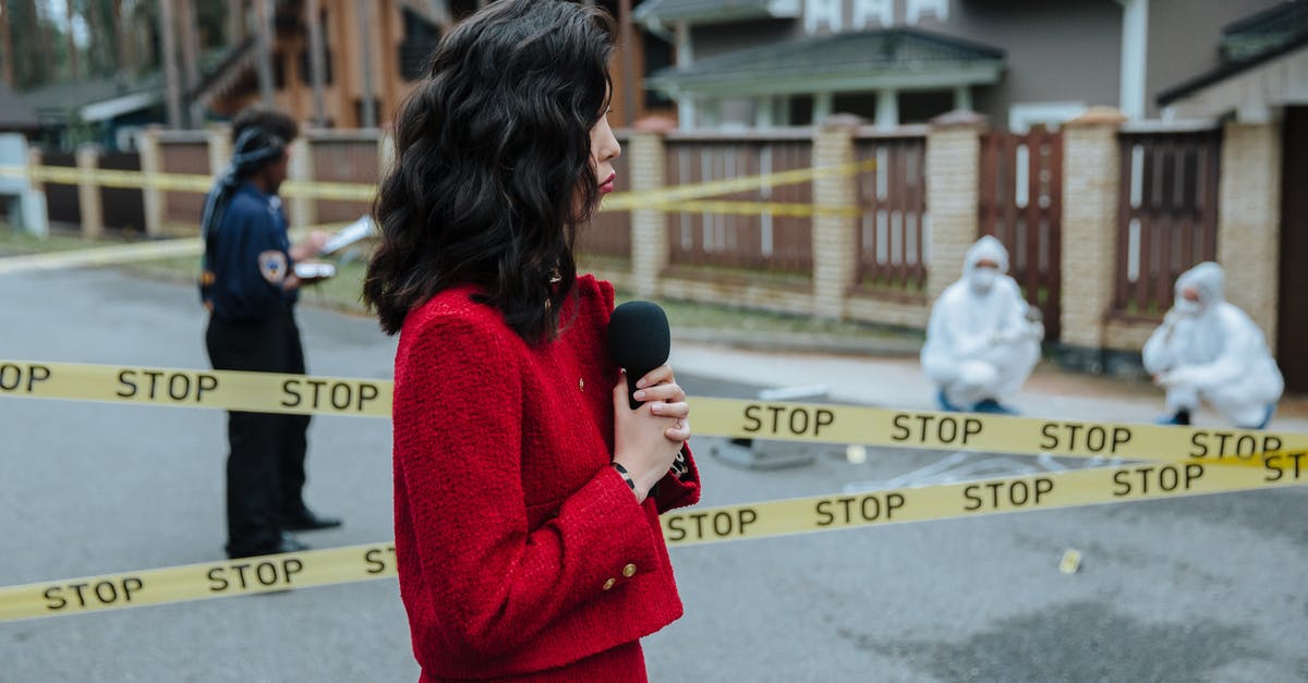 Reporting a cancelled visa - Woman in Red Blazer Holding a Microphone