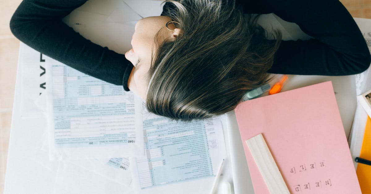 Required Documents for a UK visa [duplicate] - Woman in Blue Long Sleeve Shirt Lying on White Printer Paper