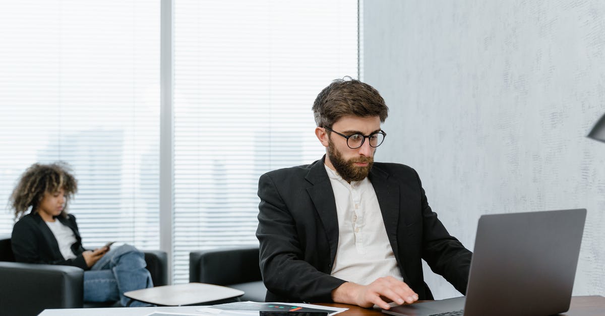 Reservation is trying to change the price of a room - Man in Black Suit Jacket Using Macbook Pro