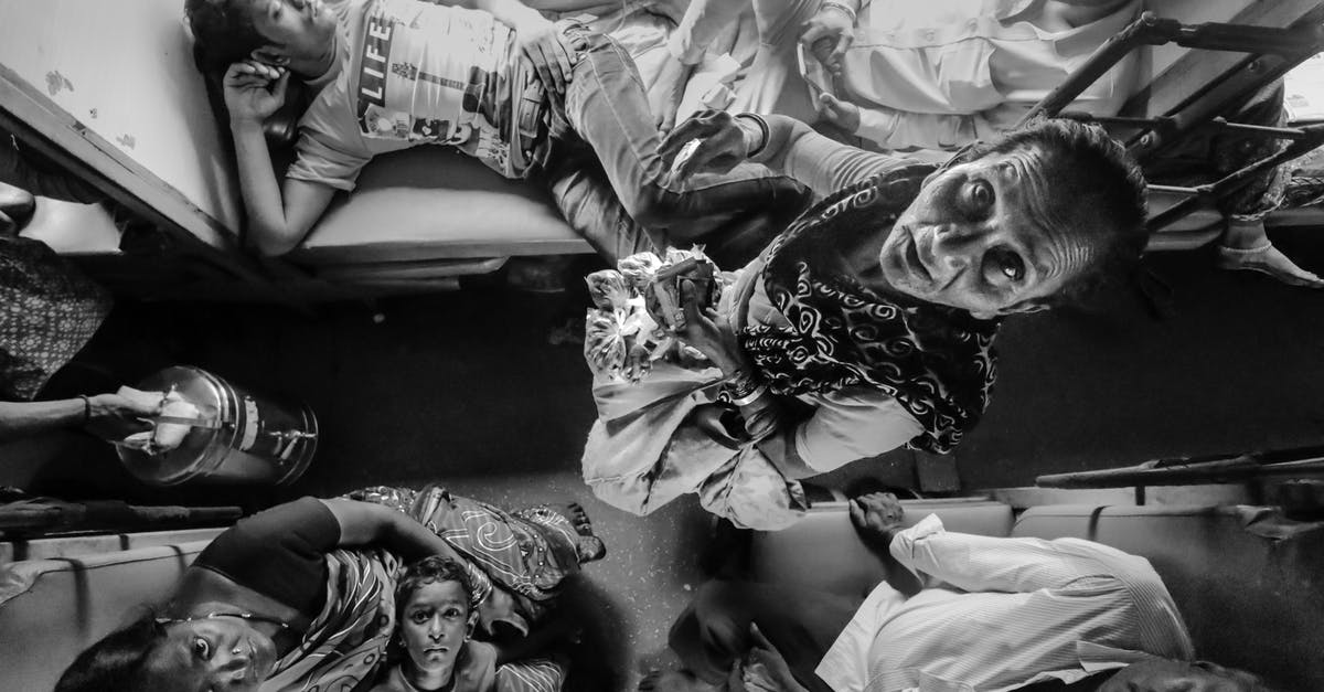 RESVN SUSPENDED status for indian train - Grayscale Photography of Group of Person