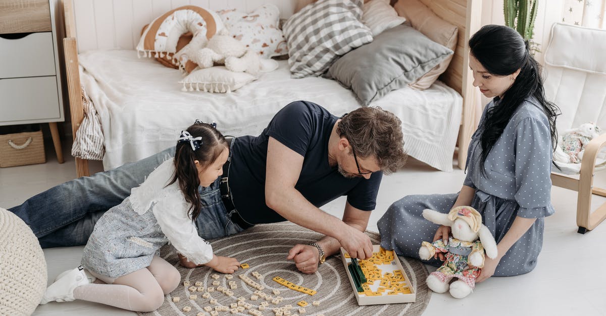 Retired Parents - Apply Visitor Visa - A Happy Foster Family Playing Scrabble