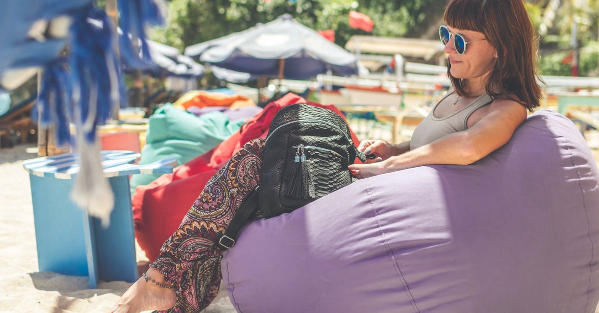 Retroactive duty charged on reimportation of luxury purse to Canada - Woman Wearing Gray Tank Top Sitting on Purple Bean Bag