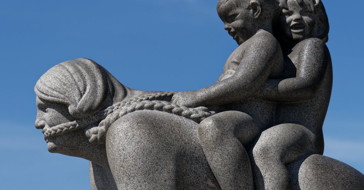 Riding the Paris Metro with a kid trailer - Gray Concrete Statue Under Blue Sky