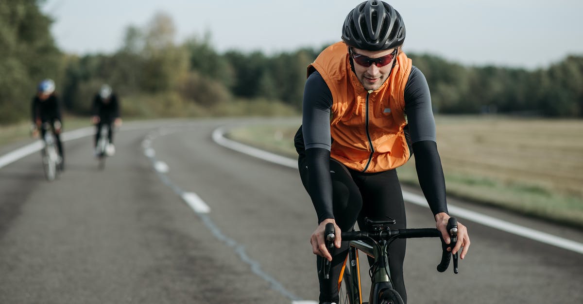 Risks of cycling across minefield [closed] - Close-Up Shot of a Cyclist Riding a Bike on the Road