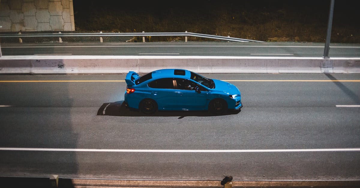 Road trip to Tromsø (polar circle) in late May: what tires? - Blue car driving on road in late evening