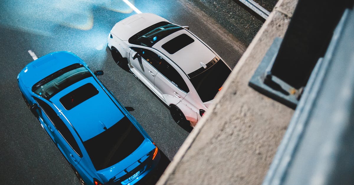 Road trip to Tromsø (polar circle) in late May: what tires? - From above of modern automobiles with bright lights riding on asphalt road with marking lines at night