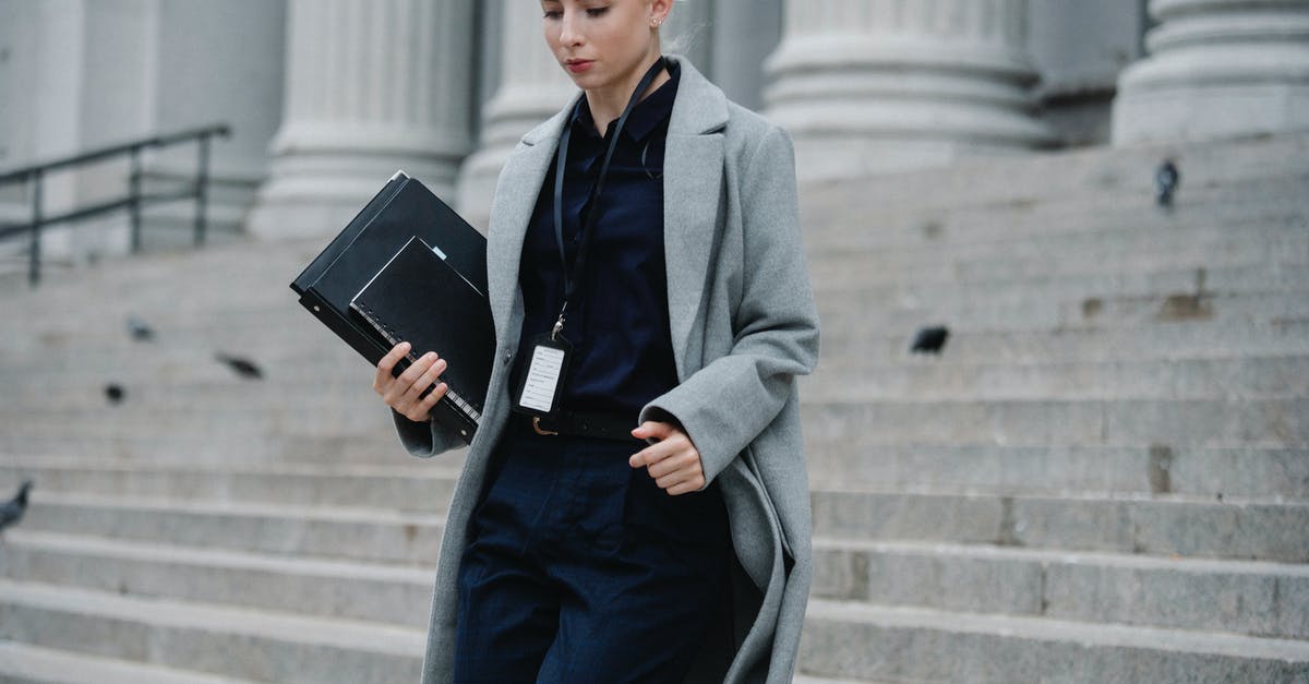 Romanian business visa Member state of first entry - Serious businesswoman hurrying with documents from courthouse