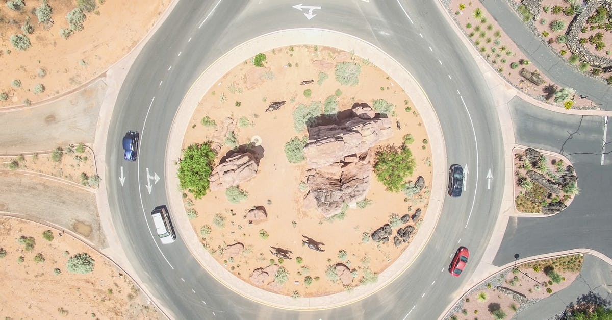 Roundabout in left drive countries - Aerial Photo of Four Cars on round about at Daytime