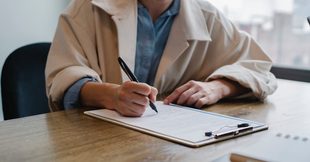 Russia visa application: no surname to fill in - Focused woman writing in clipboard while hiring candidate