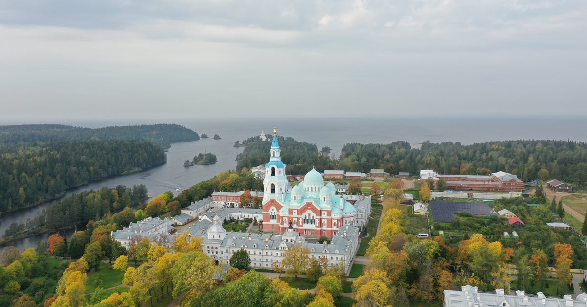 Russia visa application: no surname to fill in - White and Red Concrete Building Surrounded by Green Trees Under White Clouds