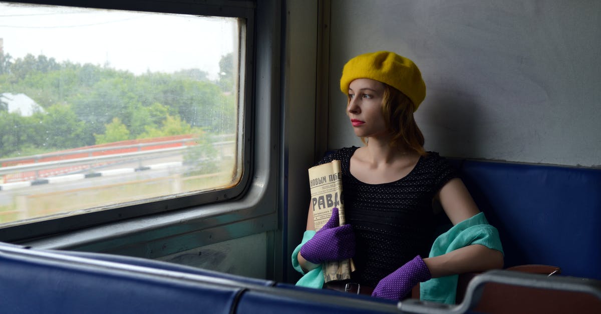 Russia visa registration when staying on the move - Pensive woman with newspaper in train