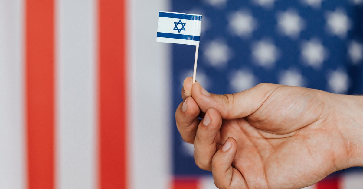 Russian citizen visiting the US [duplicate] - Crop person showing handmade flag of Israel