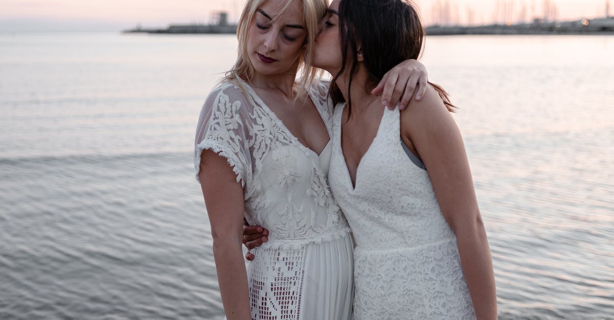 Safe to travel to Yerevan with my wife - Woman Kissing Woman While Standing Near Body of Water