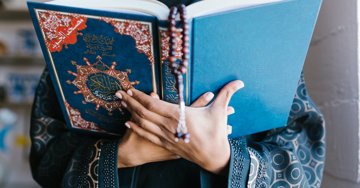 Safety of travelling to Muslim countries/Israel during Ramadan [closed] - Person Holding Blue Holy Book