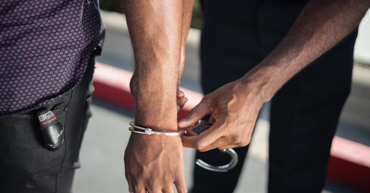 Safety [petty crimes, mostly] in Japan - Police Officer Putting Handcuffs on Another Person