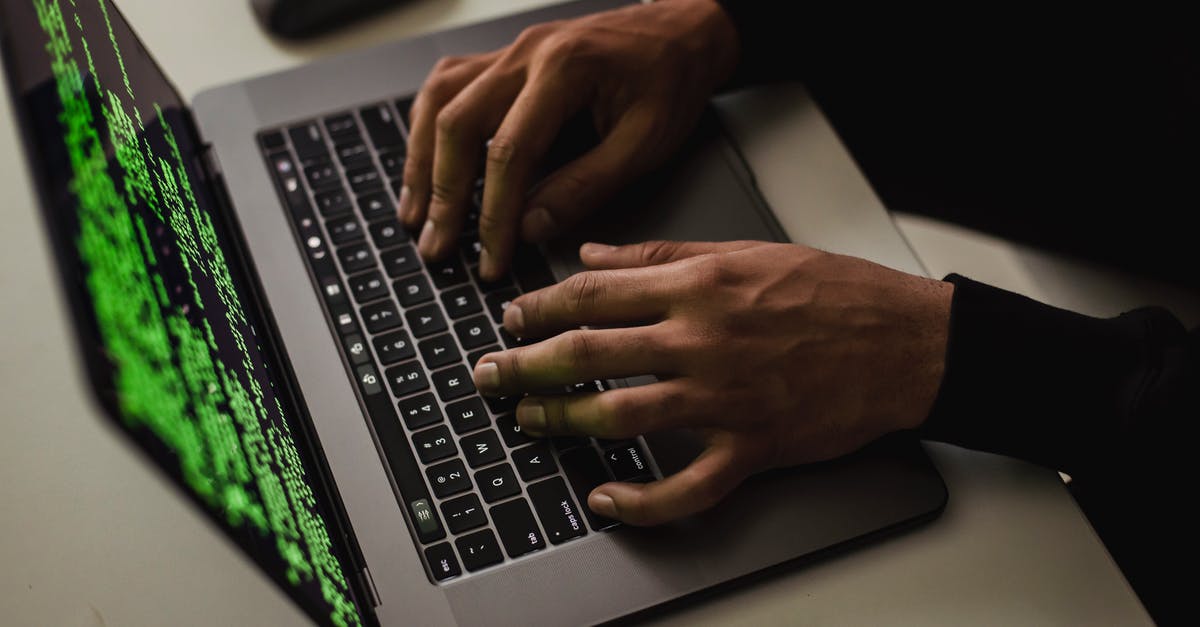 Safety: What data is available on crime in NYC in 2013? - From above of crop anonymous male hacker typing on netbook with data on screen while sitting at desk