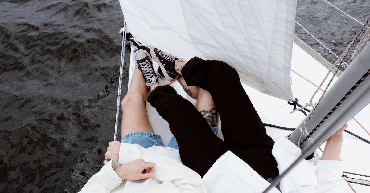 Sail & Rail to from Ireland to the Isle of Man - Woman in Black Tank Top Lying on White and Blue Hammock