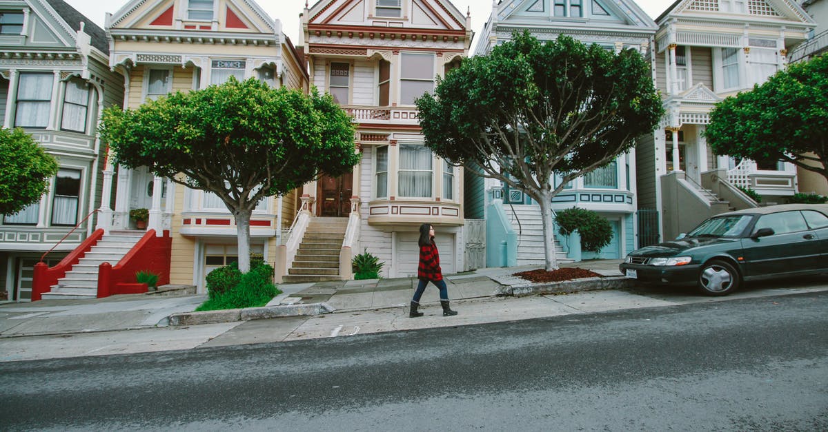 San Francisco: Getting from Union Square to Hawk hill - Woman Walking Toward Black Sedan Parked In Front of Colorful Houses