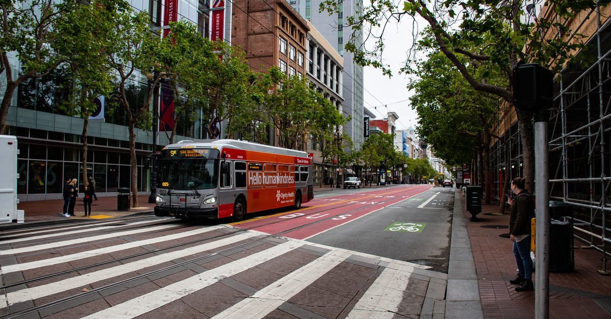 San Francisco to Los Angeles: bus or plane? - Red and Gray Passenger Bus Near High-rise Building