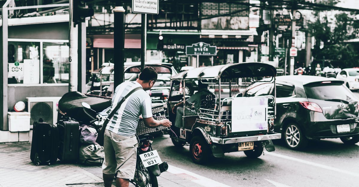 San Ysidro Pedwest parking - Man in White T-shirt and Black Pants Riding on Black and White Auto Rickshaw during