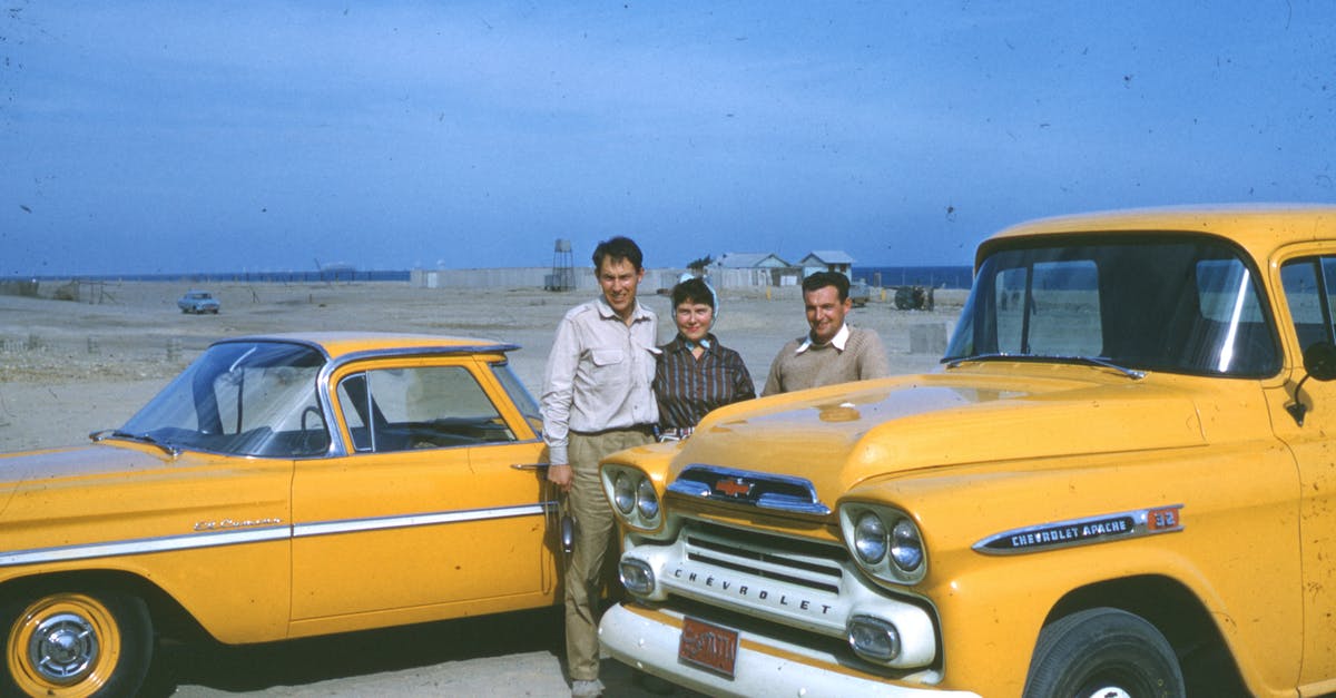 saudi labour can visit kuwait - Two Men and A Woman Standing Beside Classic Yellow Vehicles