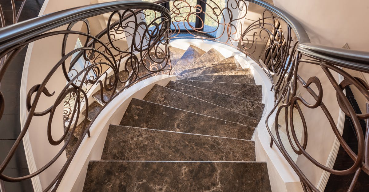 Schengen Applicant Form: Question on Residence Status - From above of spiral stairway with marble steps and metal railings with decorative elements located in modern light building with window