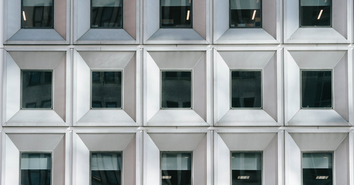 Schengen Applicant Form: Question on Residence Status - Full frame background of modern multistory building with unusual architecture and shutters behind windows