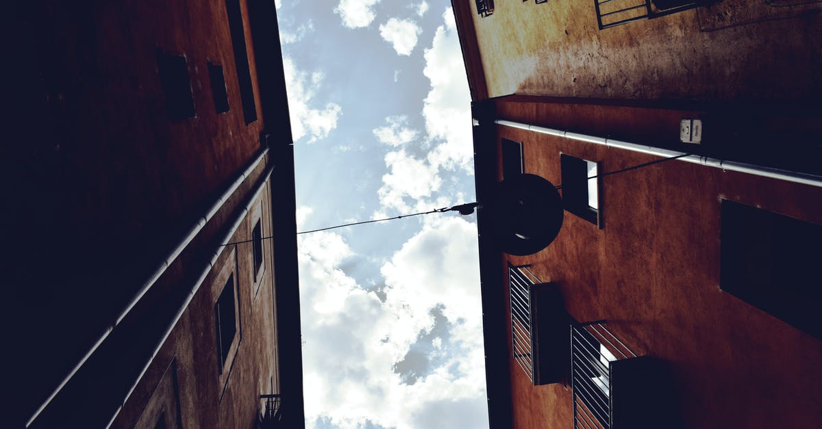 Schengen business visa extension in Spain [duplicate] - Worm's Eyeview Photography of Brown Concrete Building and White Clouds