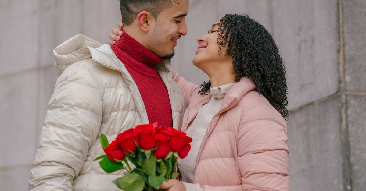 Schengen multivisa - duration each 180 days or total? [closed] - Smiling Hispanic couple with roses bouquet hugging and looking at each other