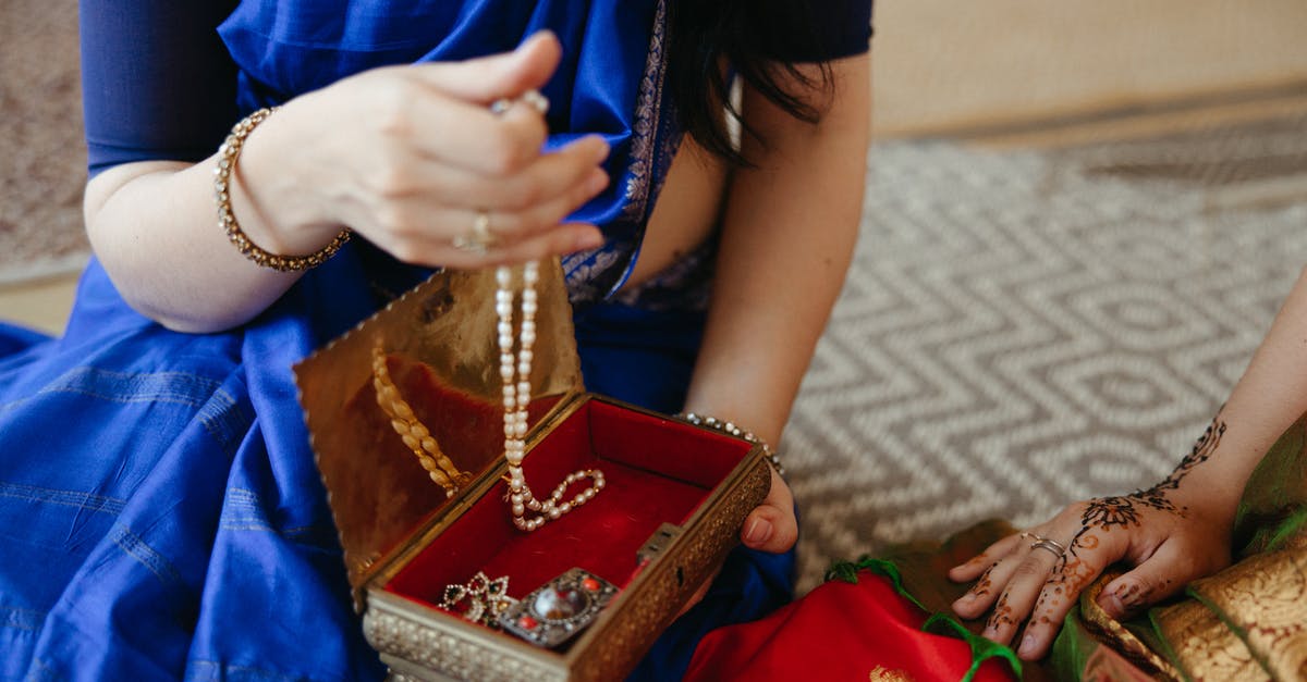 Schengen travel with minor Indian child born in Netherlands - Woman in Blue Dress Wearing Gold Bracelet